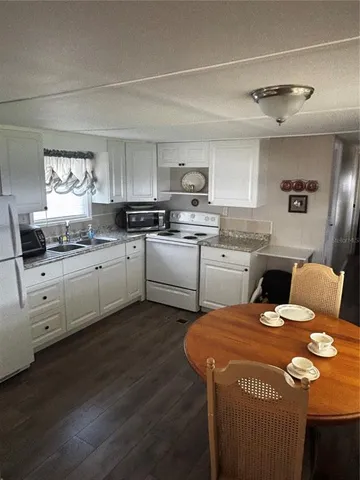 a kitchen with a stove a sink and a refrigerator