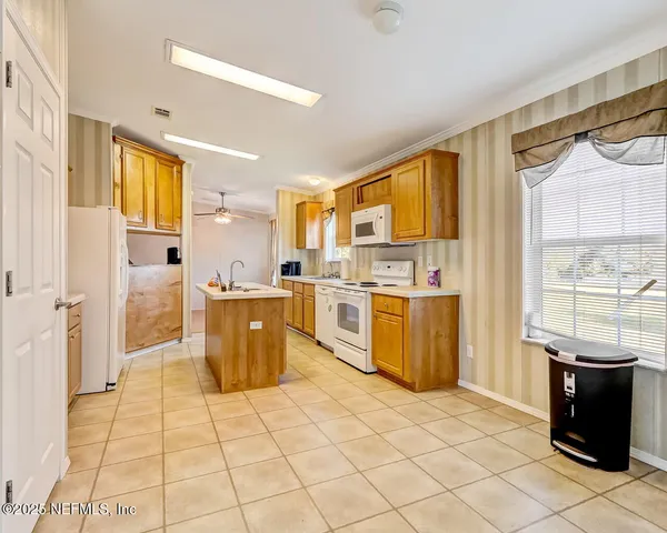 a kitchen with a sink a counter top space and stainless steel appliances