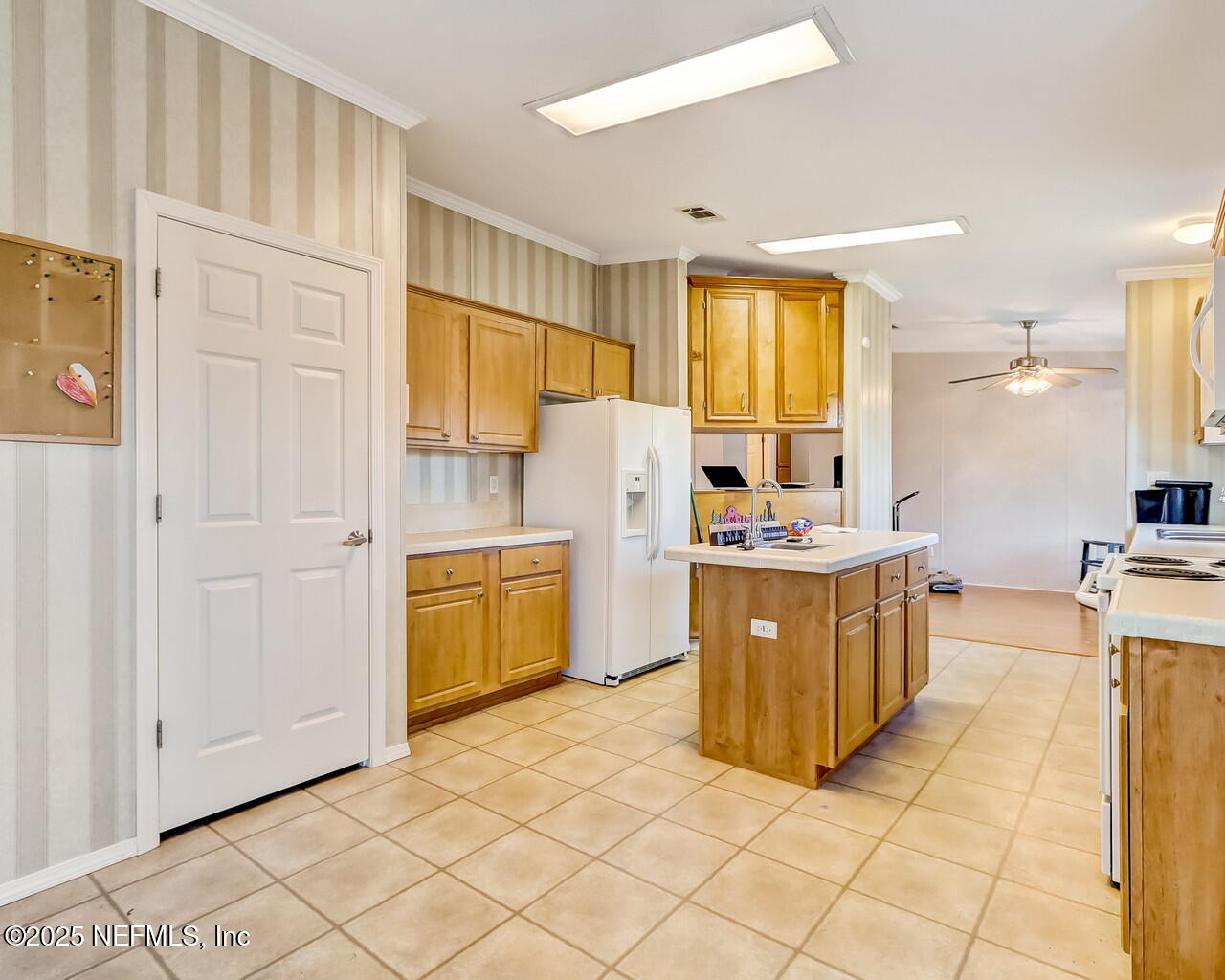 5891 Sequoia Road Keystone Heights, FL 32656 - Photo 18 of 53 a kitchen with a refrigerator a stove top oven and cabinets