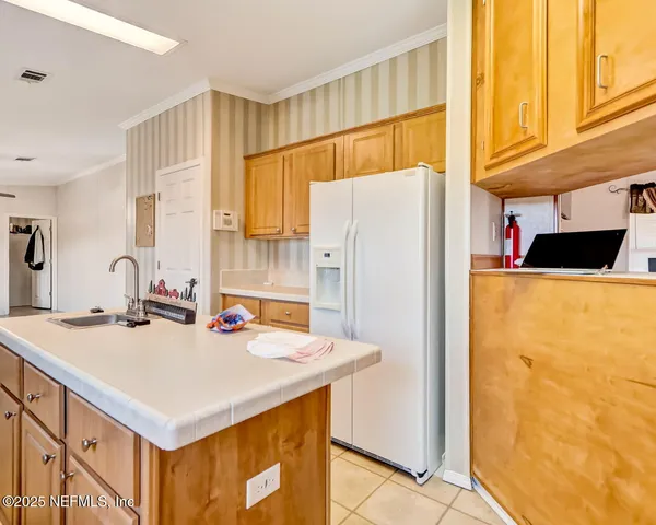 a kitchen with refrigerator and window