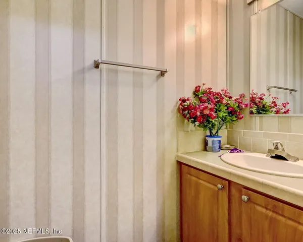 a bathroom with a sink a vanity and a mirror
