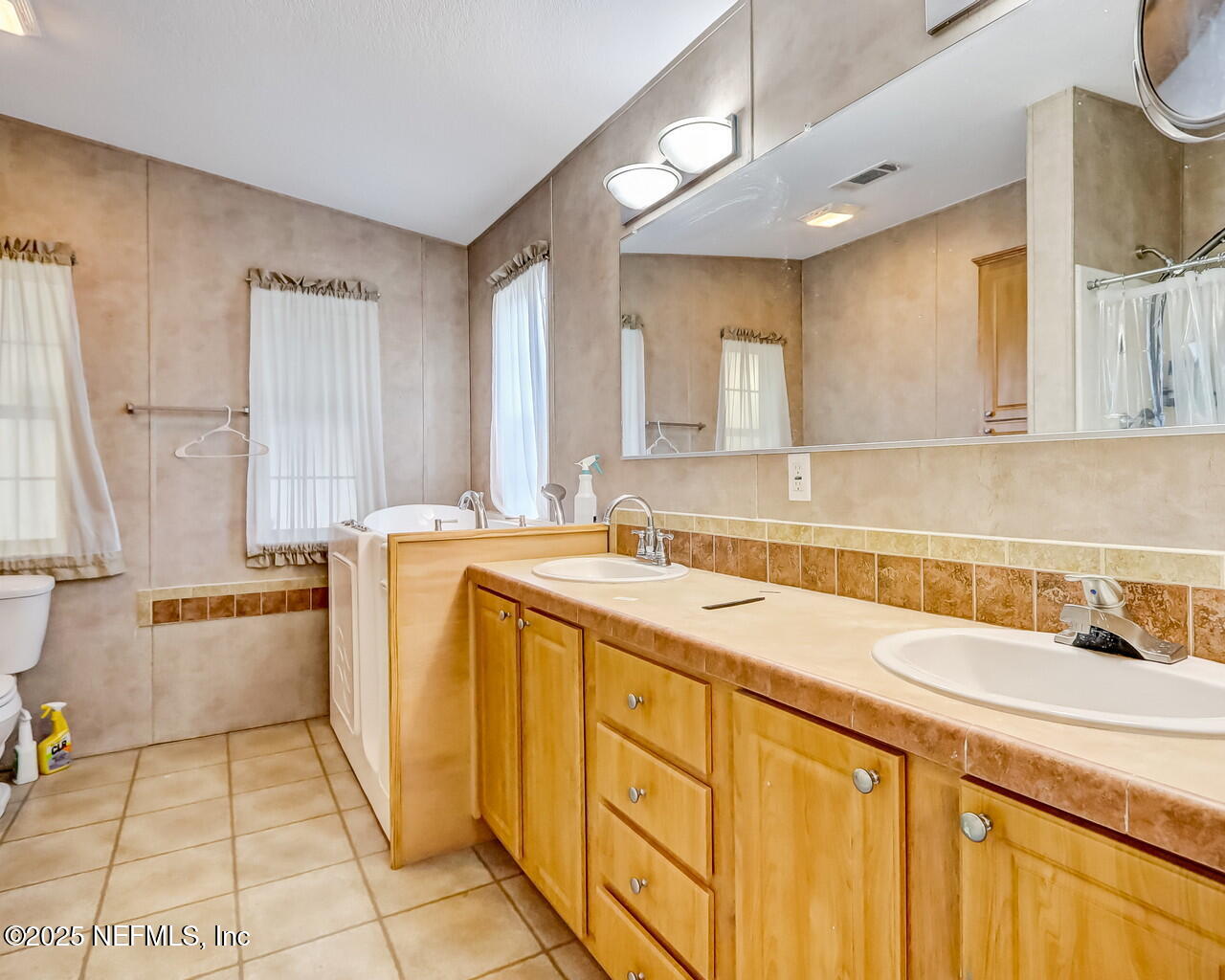 5891 Sequoia Road Keystone Heights, FL 32656 - Photo 31 of 53 a spacious bathroom with a tub sink and mirror