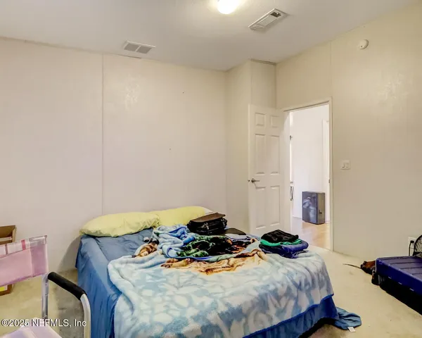 a bedroom with a bed and a table in it