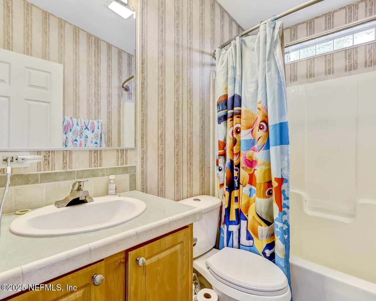 5891 Sequoia Road Keystone Heights, FL 32656 - Photo 38 of 53 a bathroom with a sink a toilet and shower curtain