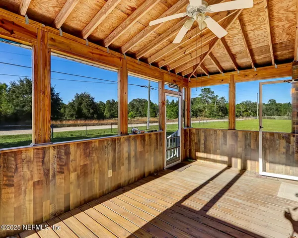 a view of balcony with wooden floor