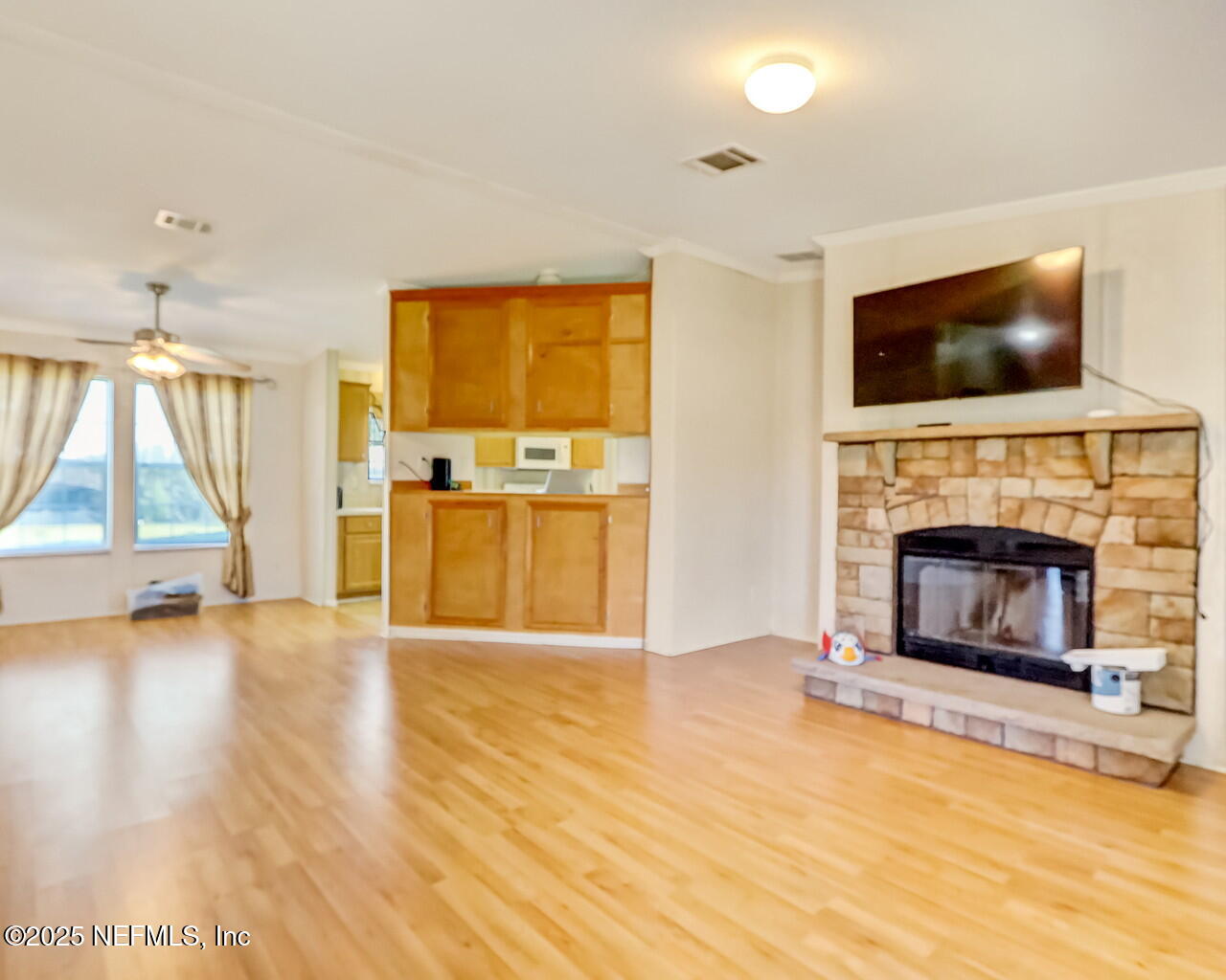5891 Sequoia Road Keystone Heights, FL 32656 - Photo 7 of 53 a living room with a fireplace a flat screen tv and a fireplace