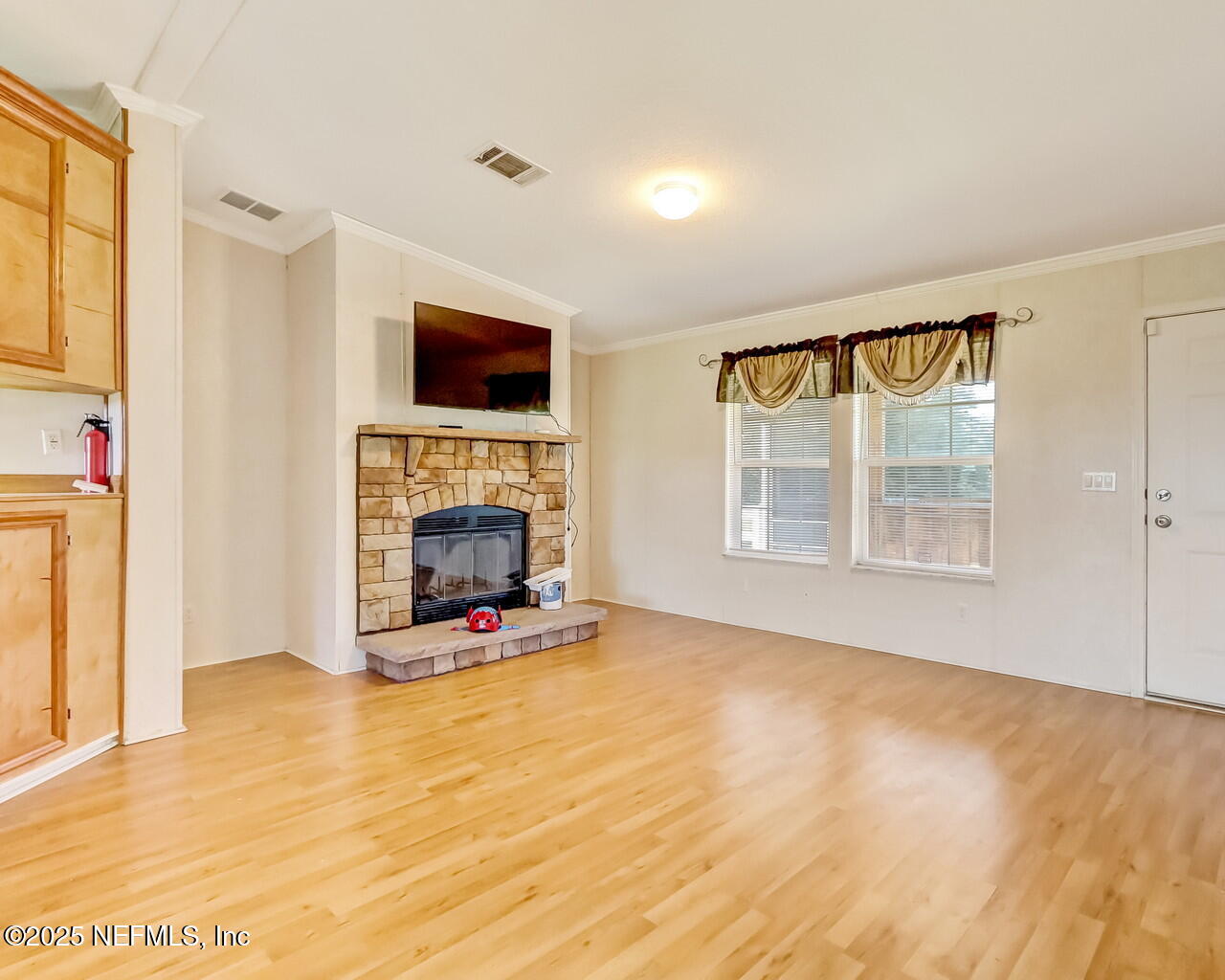 5891 Sequoia Road Keystone Heights, FL 32656 - Photo 8 of 53 a view of an empty room with a fireplace and a window