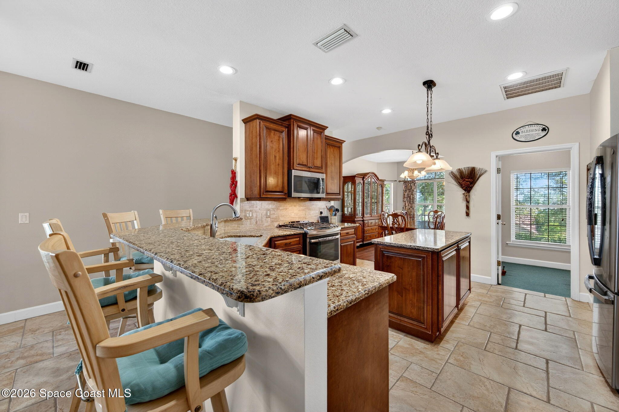 3676 South Ridge Circle Titusville, FL 32796 - Photo 19 of 74 a kitchen with granite countertop a sink a counter top space appliances and cabinets