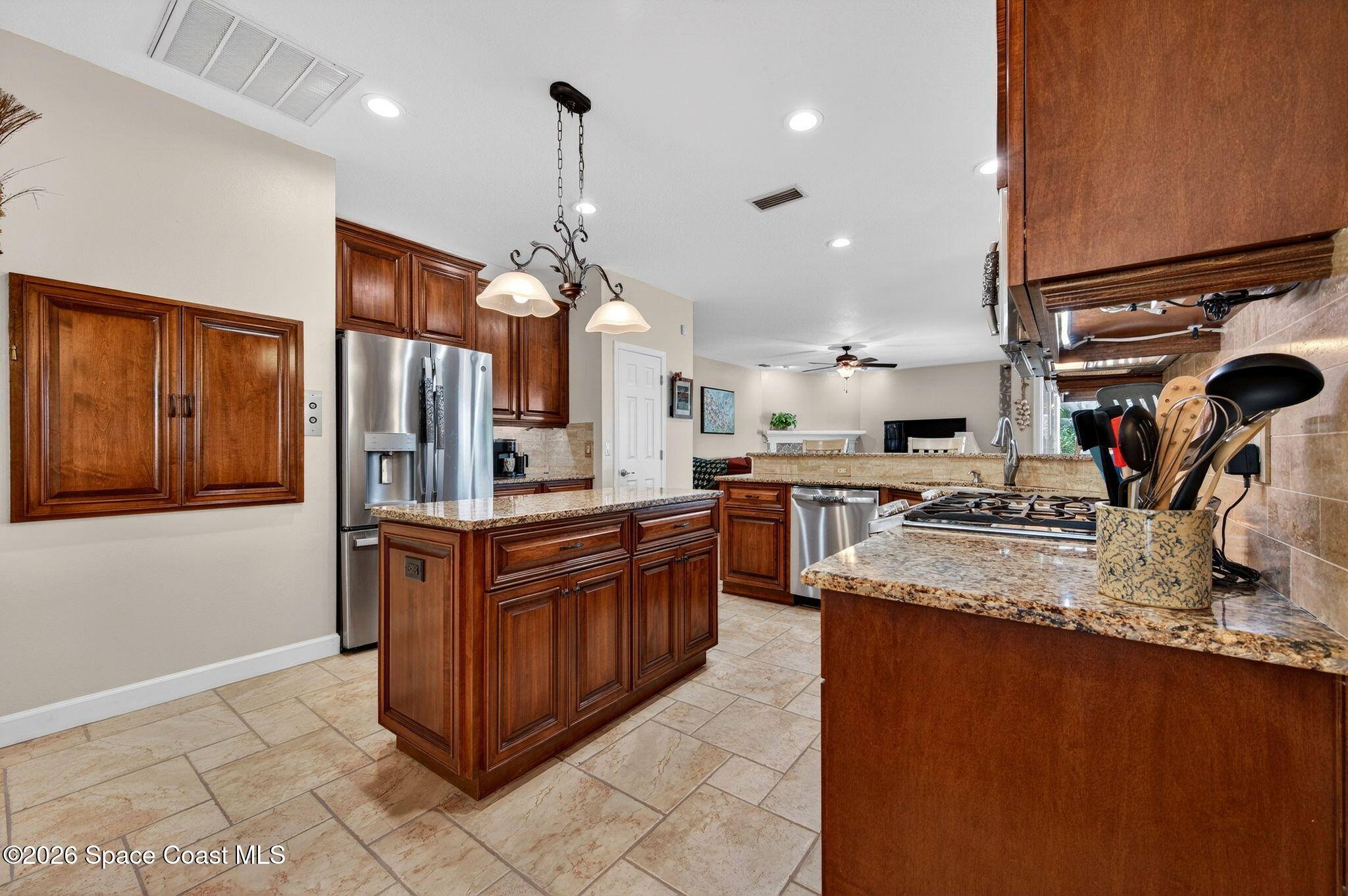 3676 South Ridge Circle Titusville, FL 32796 - Photo 21 of 74 a kitchen with stainless steel appliances granite countertop a sink stove and refrigerator