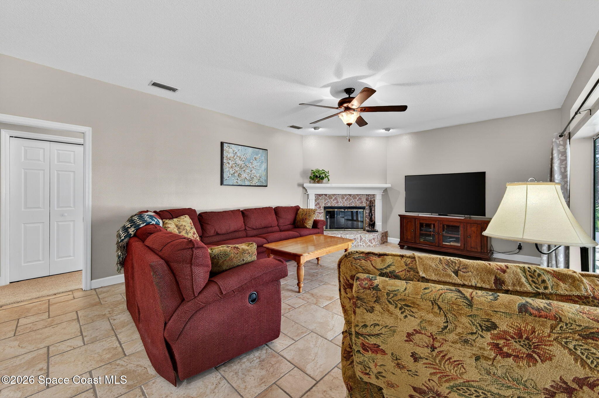 3676 South Ridge Circle Titusville, FL 32796 - Photo 24 of 74 a living room with furniture and a flat screen tv