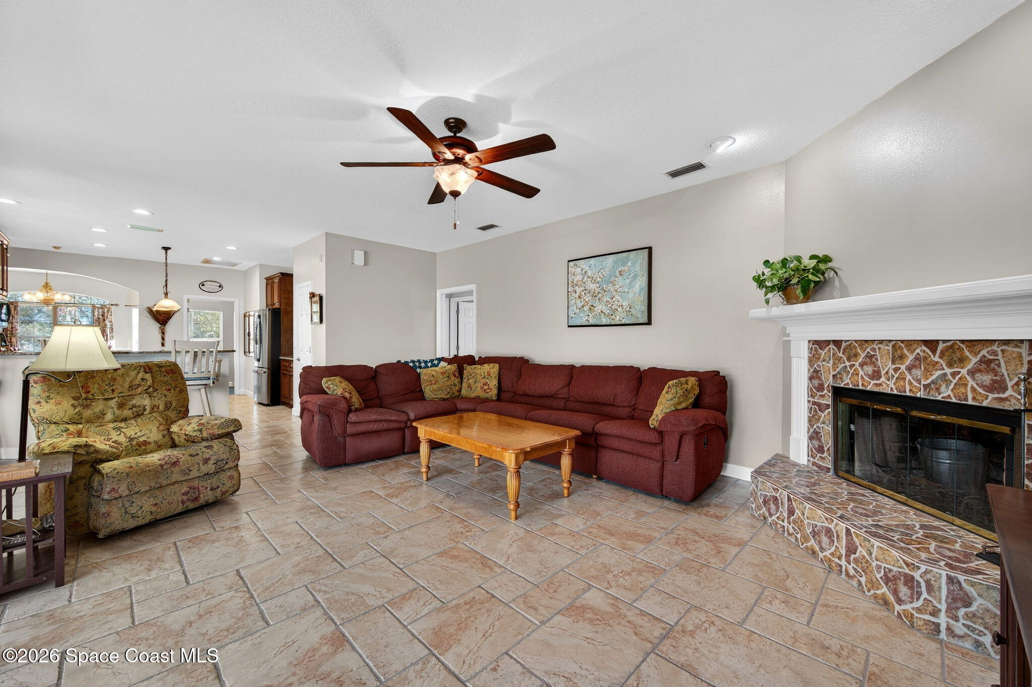 3676 South Ridge Circle Titusville, FL 32796 - Photo 27 of 74 a living room with furniture and a fireplace