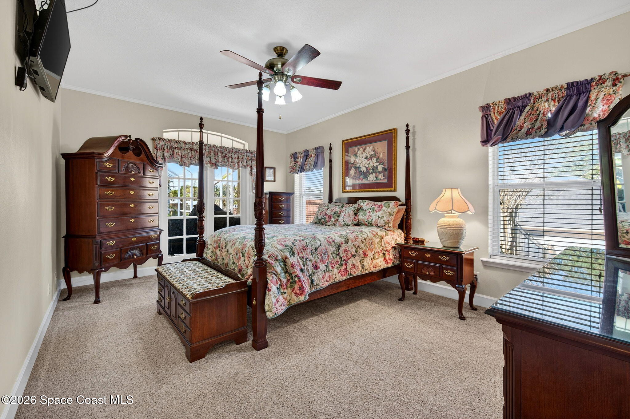 3676 South Ridge Circle Titusville, FL 32796 - Photo 31 of 74 a bedroom with a bed and a chandelier
