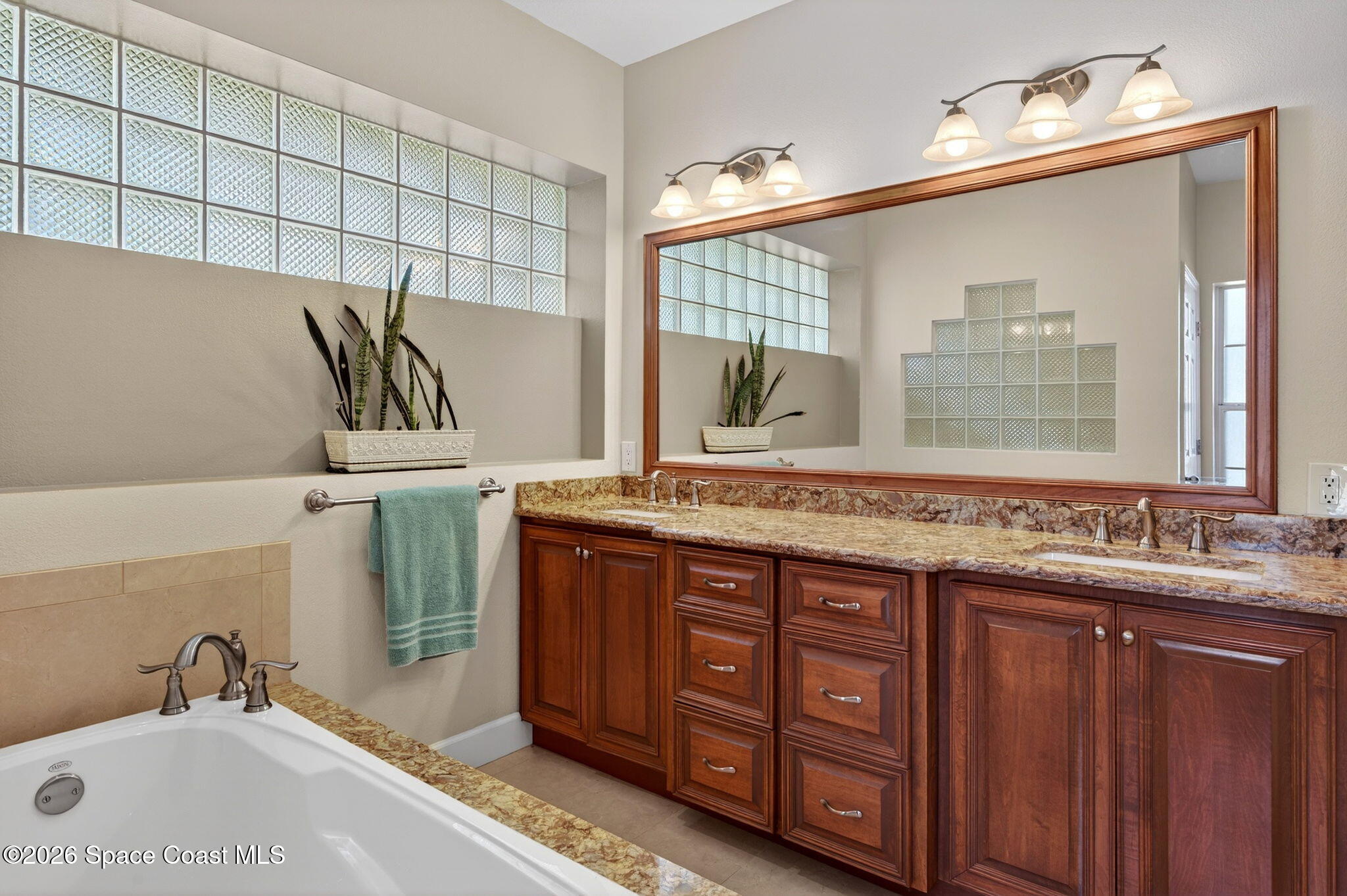 3676 South Ridge Circle Titusville, FL 32796 - Photo 35 of 74 a bathroom with a tub sink and mirror