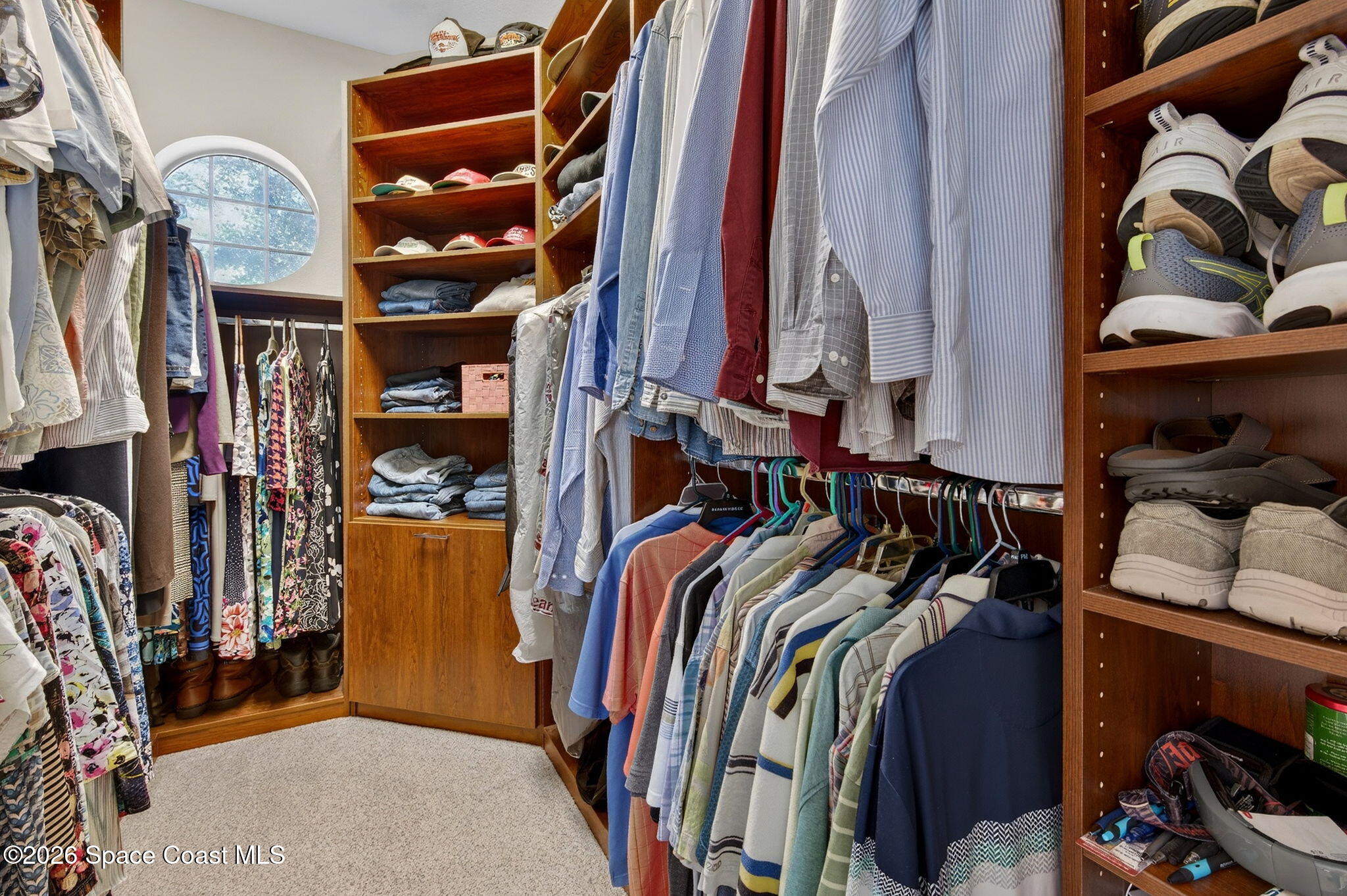 3676 South Ridge Circle Titusville, FL 32796 - Photo 36 of 74 a view of walk in closet with clothes and shoes