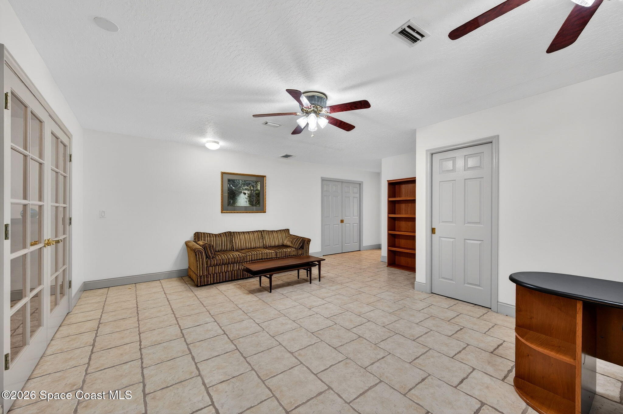 3676 South Ridge Circle Titusville, FL 32796 - Photo 49 of 74 a living room with furniture and a chandelier