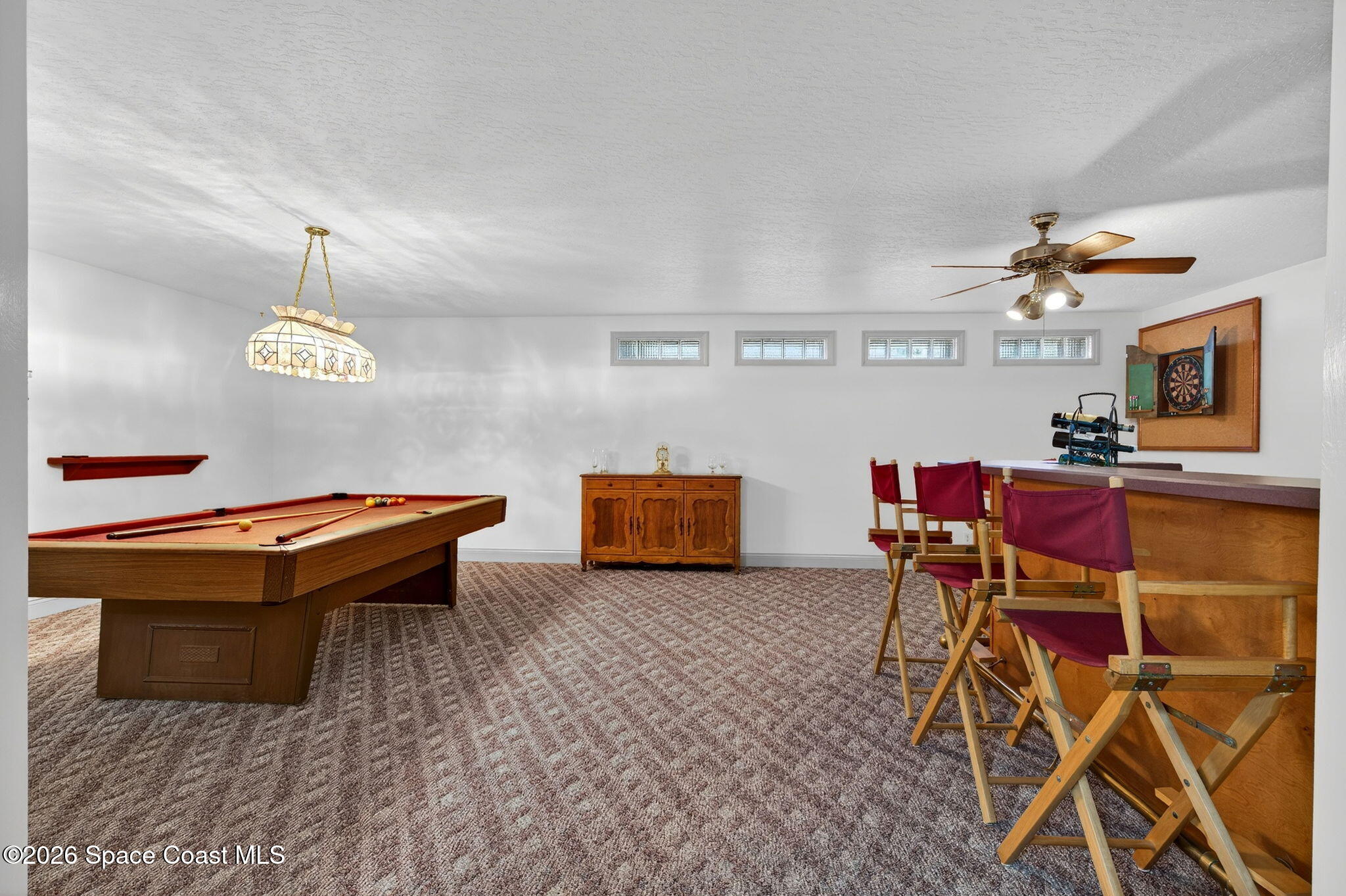 3676 South Ridge Circle Titusville, FL 32796 - Photo 52 of 74 a living room with furniture a rug and a table