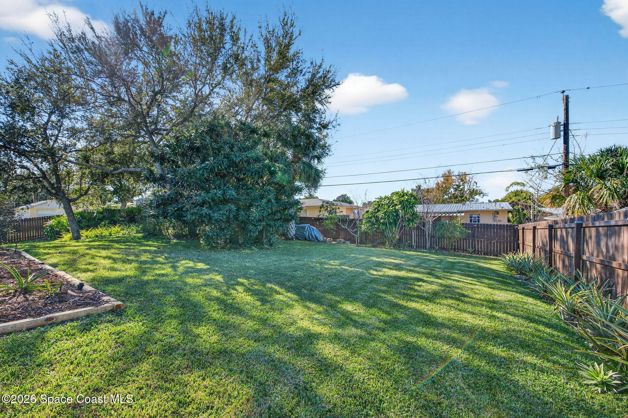 3676 South Ridge Circle Titusville, FL 32796 - Photo 69 of 74 a view of yard with green space and trees in the background