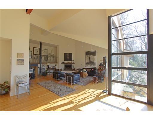 3 Cornelia Drive Greenwich, CT 06830 - Photo 2 of 16 a living room with furniture a flat screen tv and a floor to ceiling window