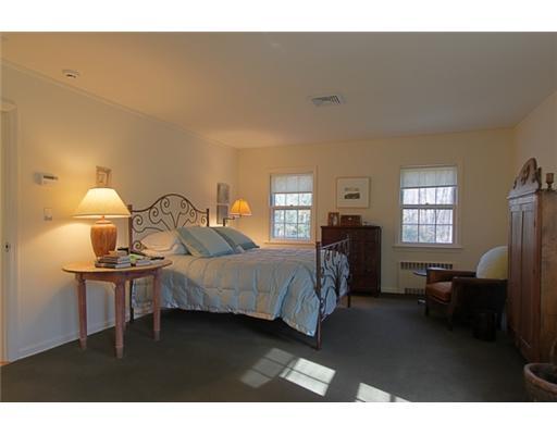 3 Cornelia Drive Greenwich, CT 06830 - Photo 8 of 16 a bedroom with a bed wooden floor and lamp