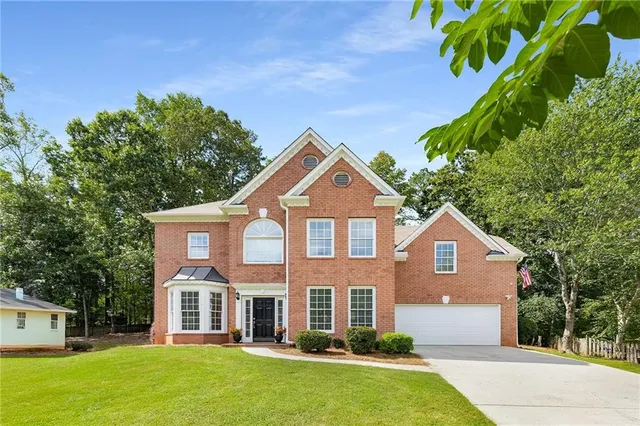 a front view of a house with a yard