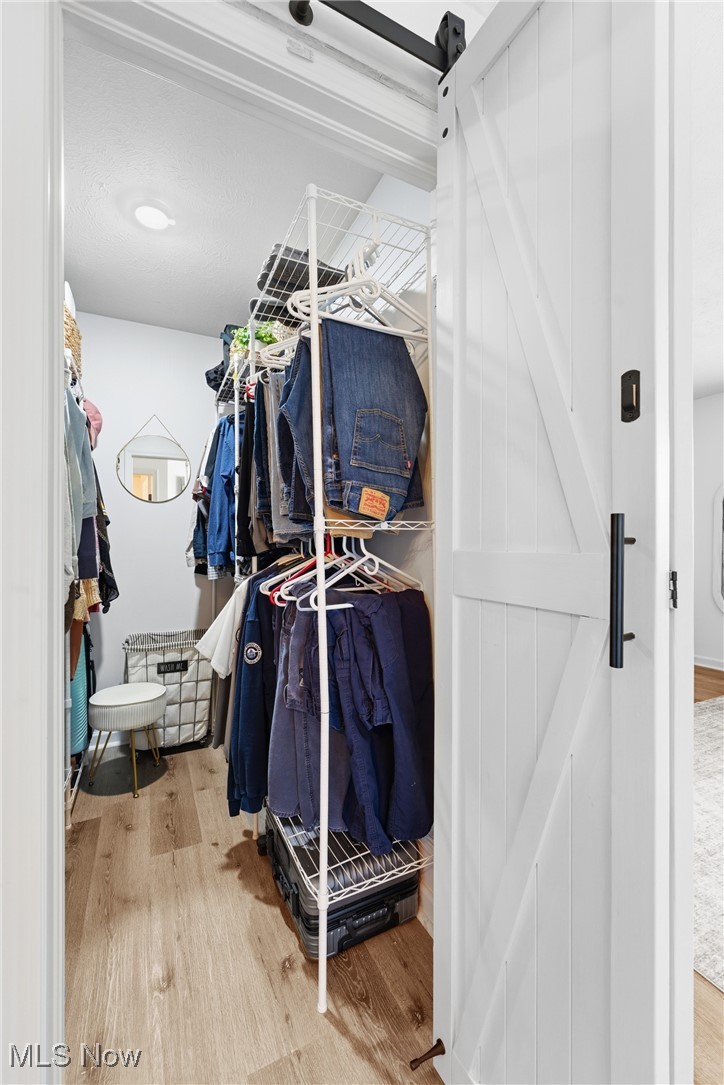 4038 Gardiner Run Akron, OH 44321 - Photo 22 of 38 Spacious closet with a barn door and light wood-style floors