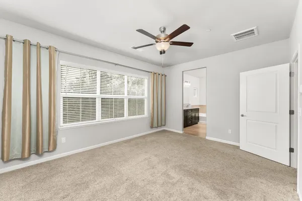 a view of a livingroom with a ceiling fan and window