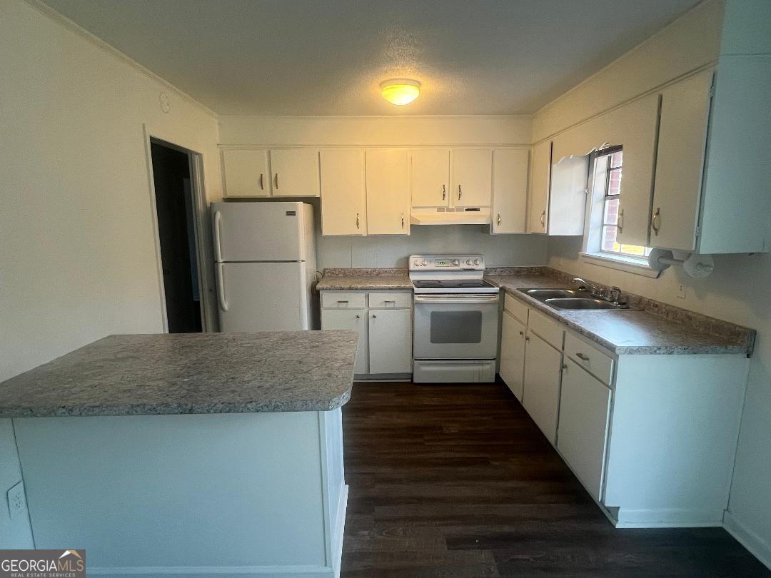 2293 Burkhalter Road Statesboro, GA 30458 - Photo 2 of 10 a kitchen with stainless steel appliances granite countertop a sink stove and refrigerator