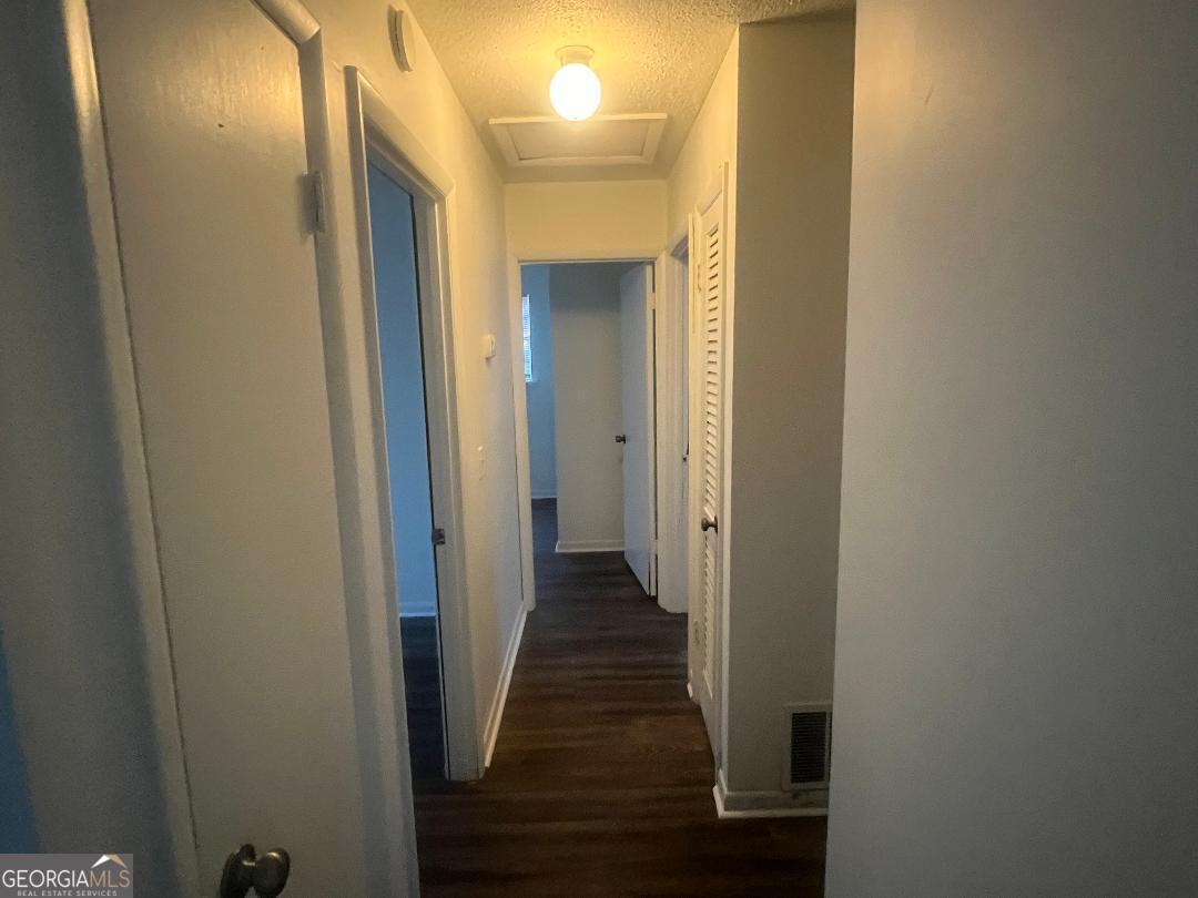 2293 Burkhalter Road Statesboro, GA 30458 - Photo 3 of 10 a view of a hallway with wooden floor