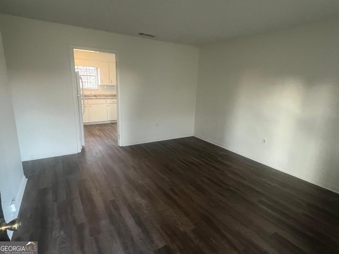 2293 Burkhalter Road Statesboro, GA 30458 - Photo 4 of 10 a view of empty room with wooden floor and fan