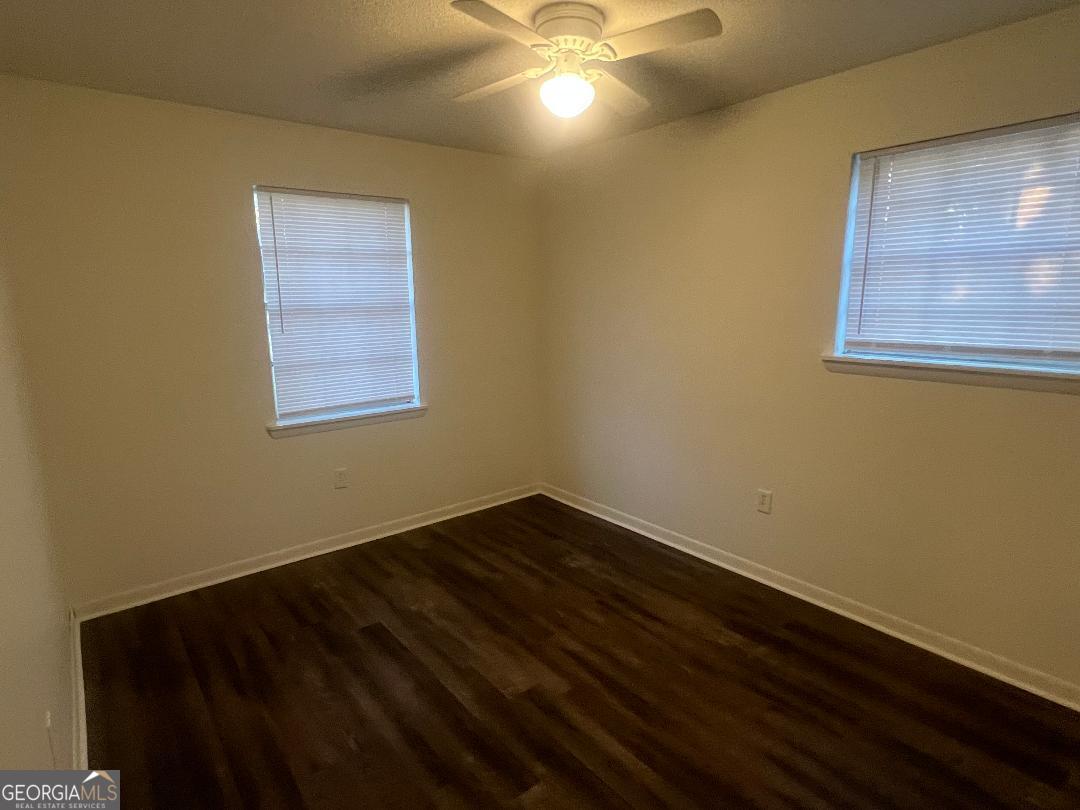 2293 Burkhalter Road Statesboro, GA 30458 - Photo 8 of 10 a view of an empty room with a window and wooden floor