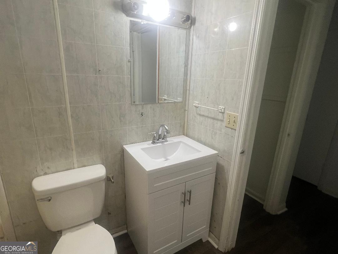 2293 Burkhalter Road Statesboro, GA 30458 - Photo 9 of 10 a bathroom with a toilet sink and mirror