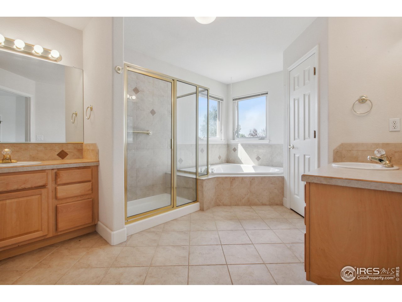 6735 Saddleback Avenue Firestone, CO 80504 - Photo 15 of 26 a bathroom with a tub sink and mirror