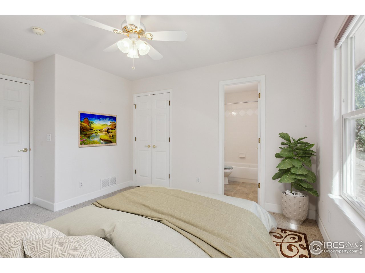 6735 Saddleback Avenue Firestone, CO 80504 - Photo 20 of 26 a bedroom with a bed and a chandelier fan