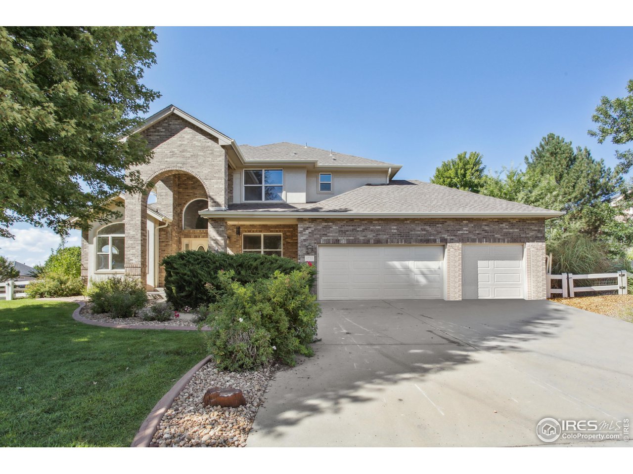 6735 Saddleback Avenue Firestone, CO 80504 - Photo 2 of 26 a front view of a house with a yard and garage