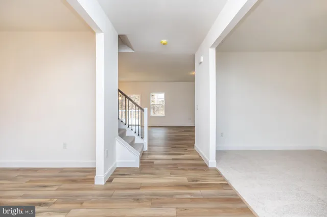 a kitchen with kitchen island granite countertop a sink a counter space appliances and cabinets