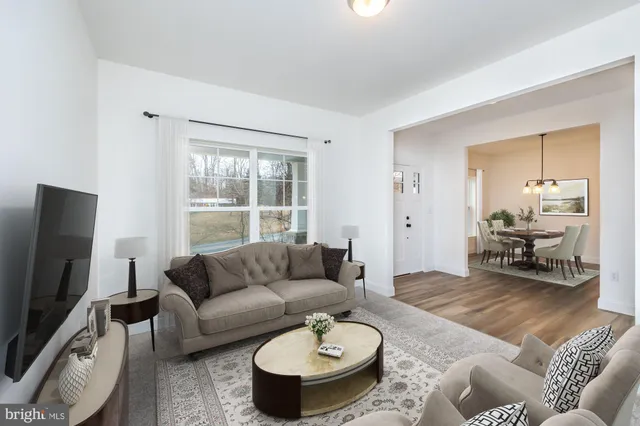 a kitchen with kitchen island granite countertop a sink a counter space stainless steel appliances and cabinets