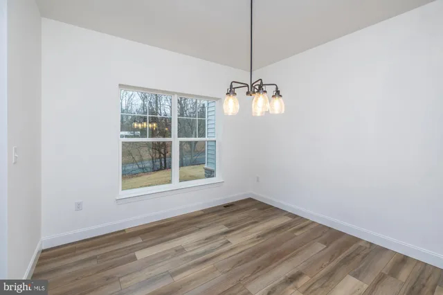 a bathroom with a sink toilet and a window