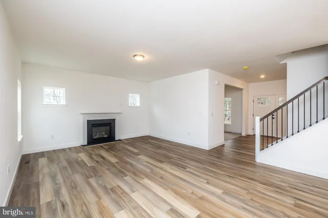 a bathroom with a sink a toilet a mirror and shower