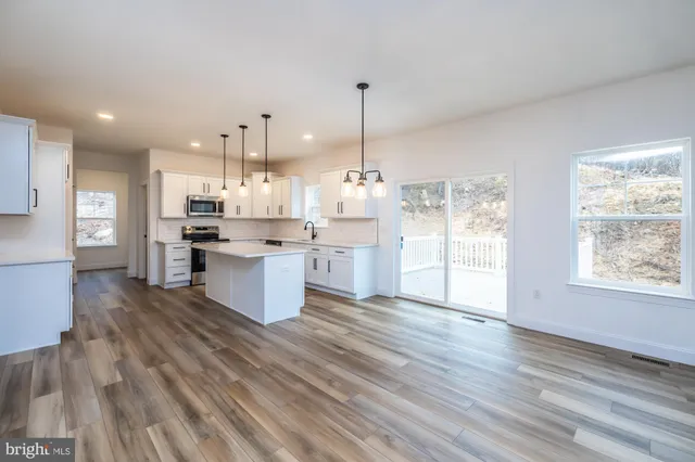 a view of a room with wooden floor