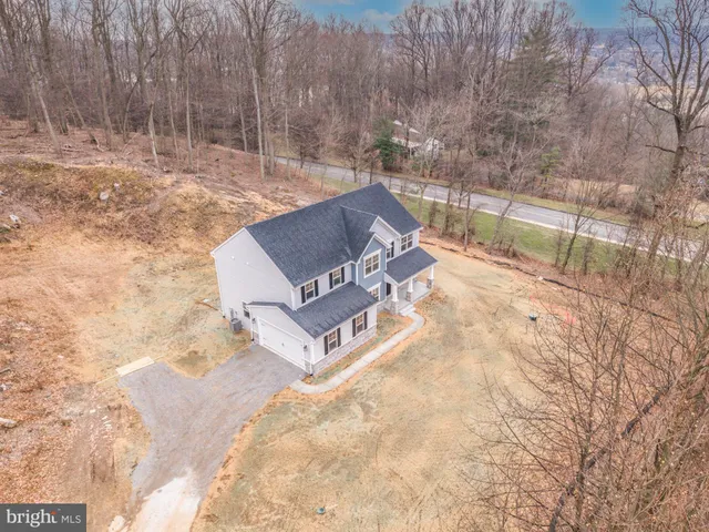 a view of a dry yard with wooden fence