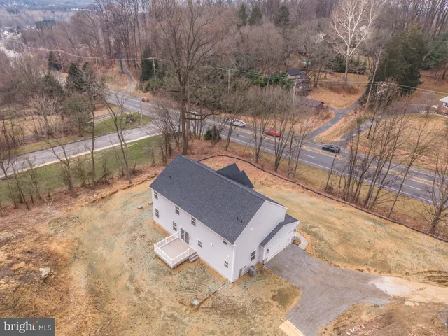 a view of a room with window hardwood floor and a ceiling fan