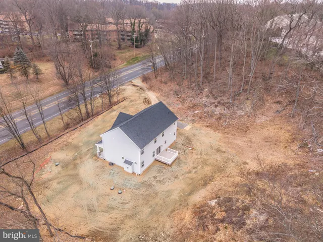 a view of a room with wooden floor and a ceiling fan