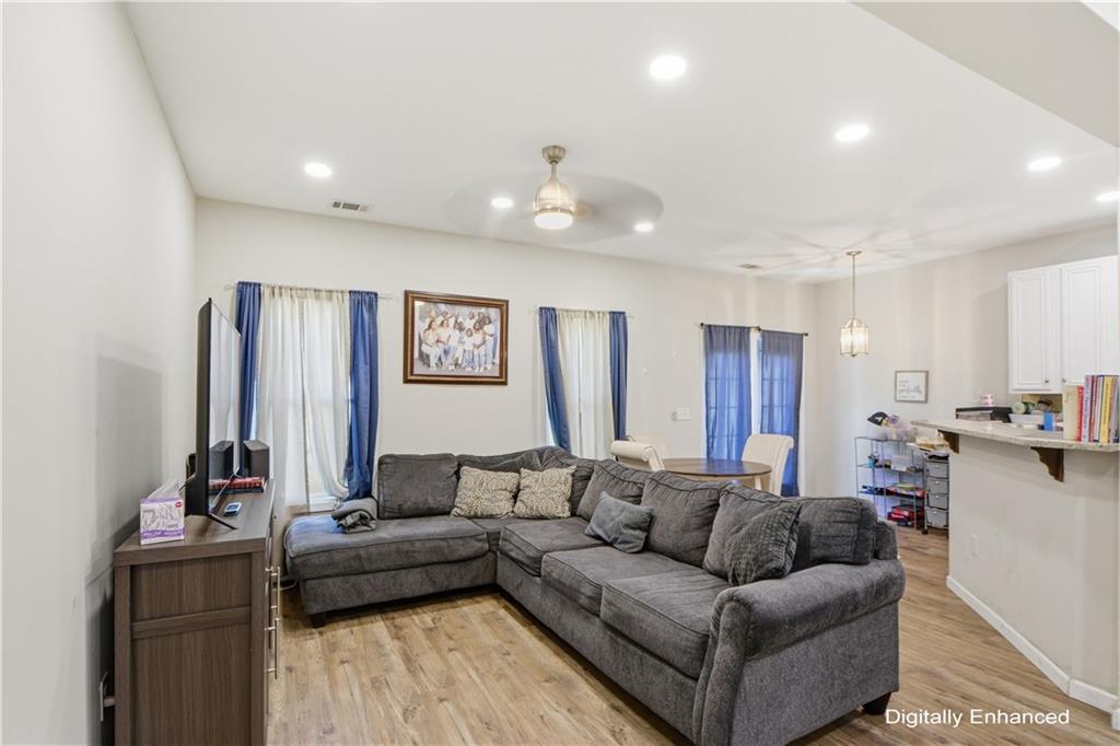 2555 Flat Shoals Road, Unit 2008 Atlanta, GA 30349 - Photo 7 of 33 a living room with furniture and a chandelier