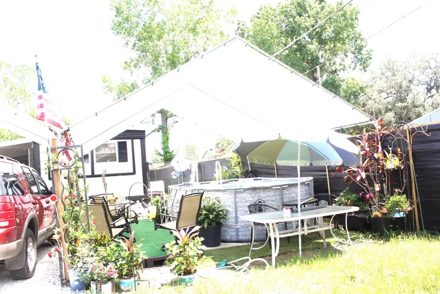 a view of a chair and tables in the backyard of a house