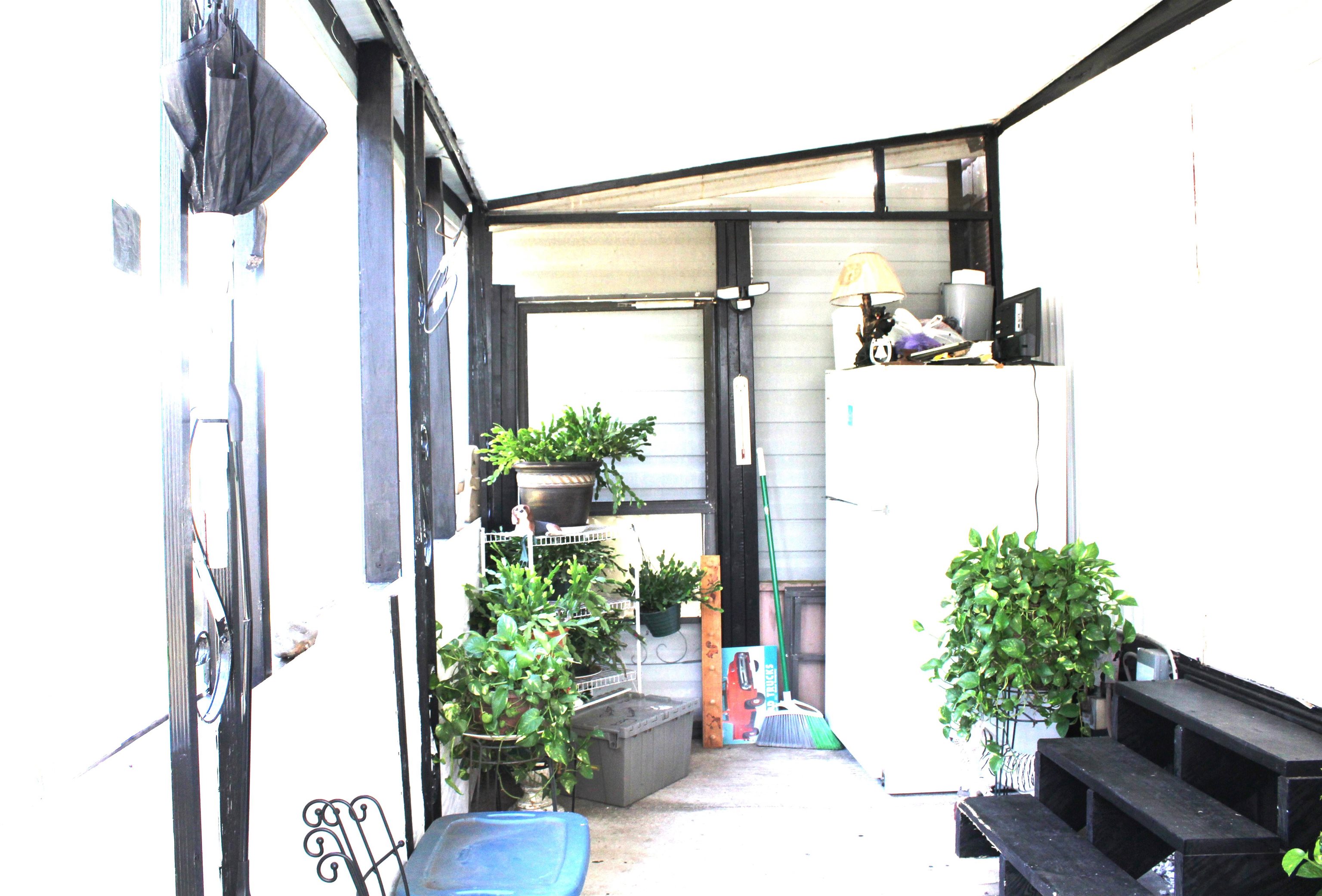 773 San Mateo Road Satsuma, FL 32189 - Photo 4 of 9 a front view of a house with a large window and flower pot