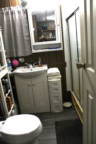 a bathroom with a sink toilet and shower