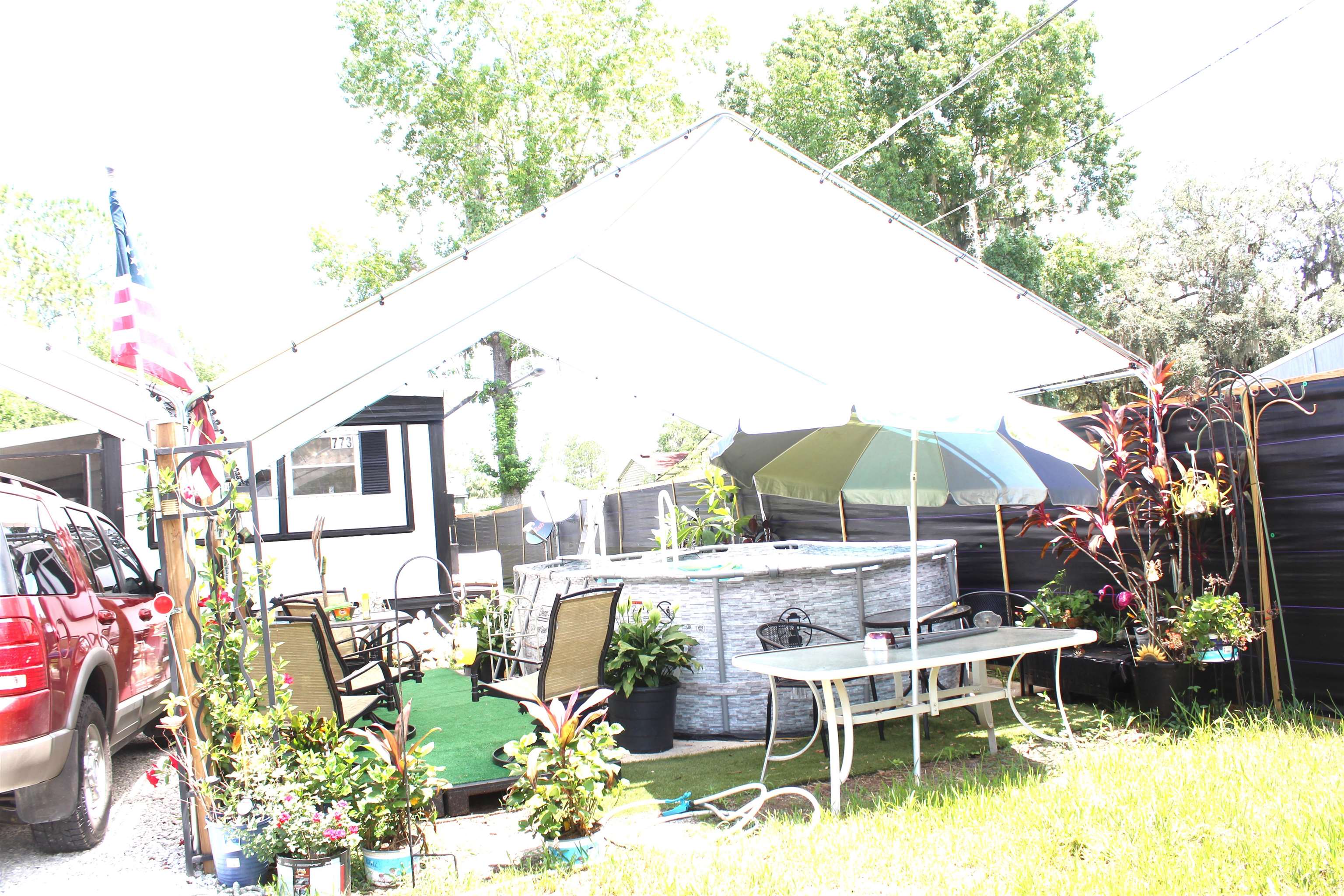 773 San Mateo Road Satsuma, FL 32189 - Photo 9 of 9 a view of a chair and tables in the backyard of a house