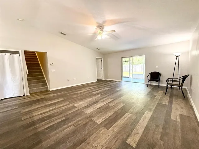 a spacious bedroom with a bed and a flat screen tv