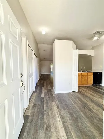 a view of a hallway with wooden floor