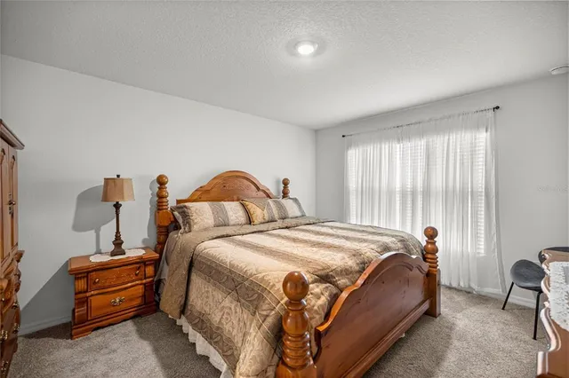 a bedroom with bed and a window